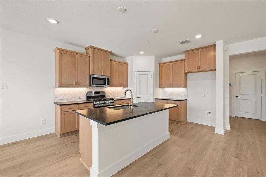 The spacious kitchen island offers the perfect gathering space for friends and family! The spacious kitchen island offers the perfect gathering space for friends and family!