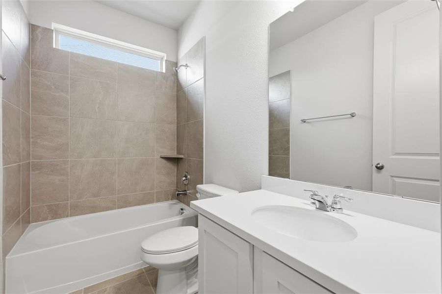 Bathroom with bathing tub / shower combination, vanity, and light tile patterned flooring Bathroom with bathing tub / shower combination, vanity, and light tile patterned flooring