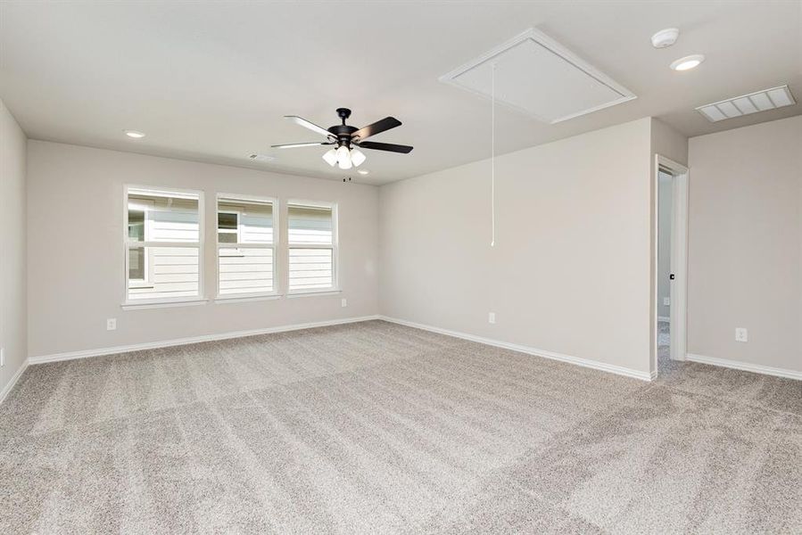 Unfurnished room with recessed lighting, attic access, light carpet, and ceiling fan
