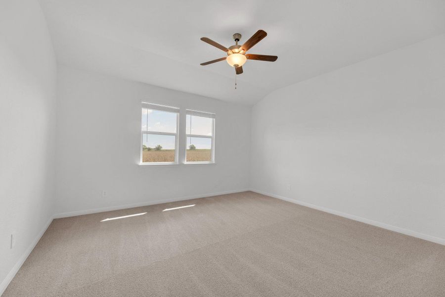 Spare room with light carpet, lofted ceiling, and ceiling fan Spare room with light carpet, lofted ceiling, and ceiling fan