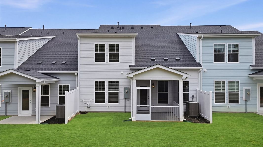 Warm and inviting outdoor living space with a covered screened-in porch and tasteful finishes at Village at Midway Warm and inviting outdoor living space with a covered screened-in porch and tasteful finishes at Village at Midway