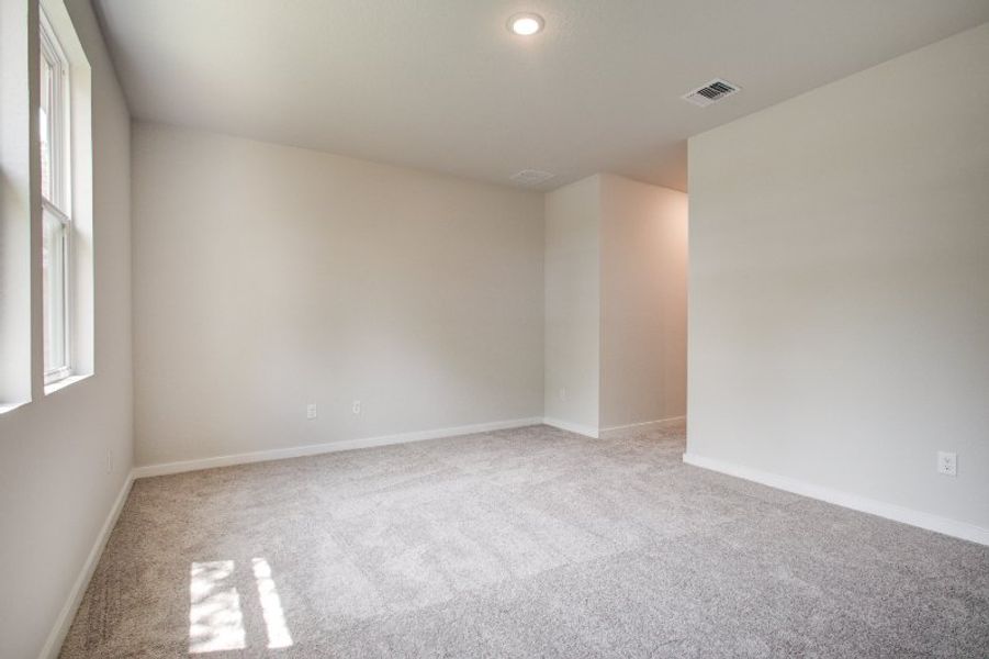 A room with a carpet and a window. A room with a carpet and a window.