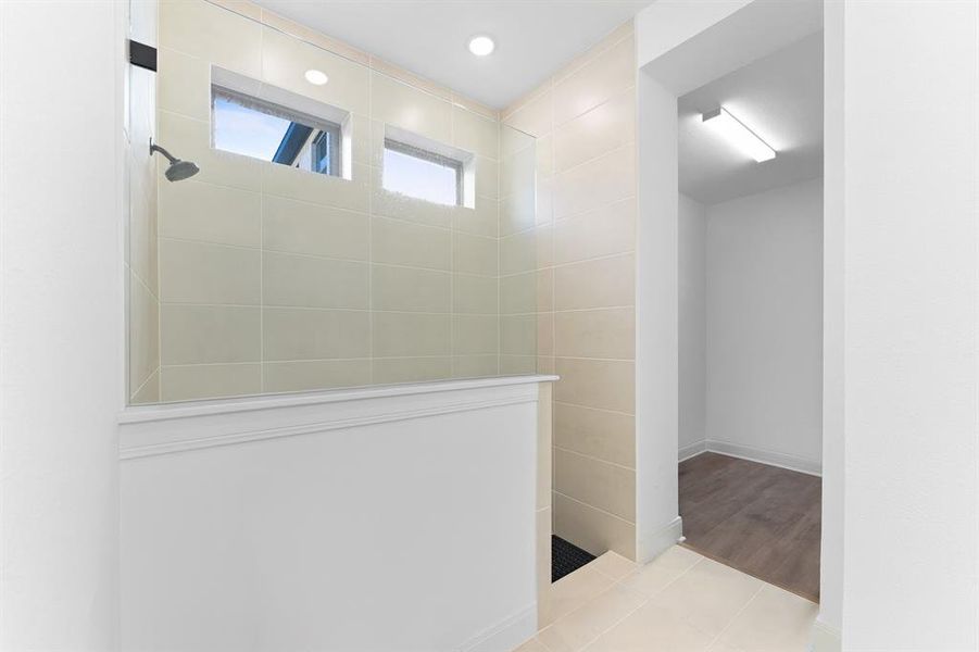 Full bath featuring a walk in shower, light tile patterned floors, and recessed lighting Full bath featuring a walk in shower, light tile patterned floors, and recessed lighting