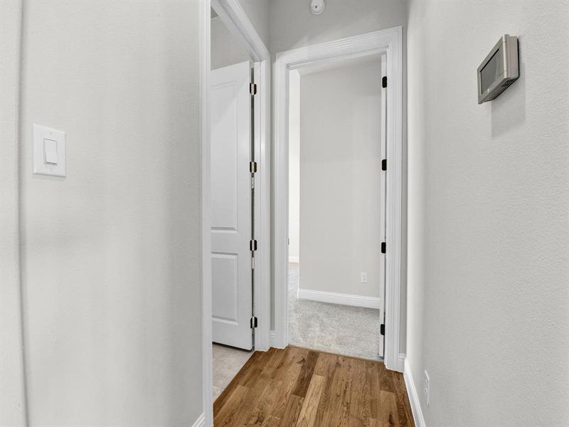 Corridor with light hardwood / wood-style floors