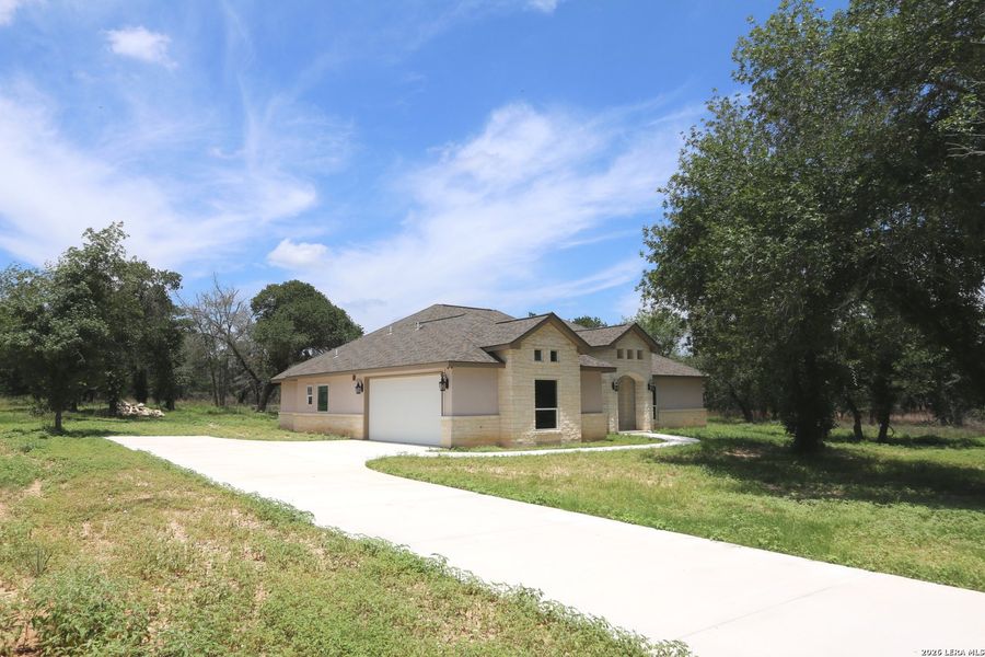 Front exterior of a new home in , Floresville, TX, highlighting curb appeal (Image 26).