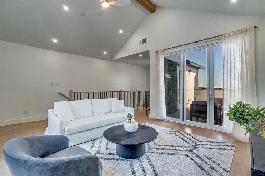 Model Home Gameroom with light wood finished floors, beamed ceiling, recessed lighting, high vaulted ceiling, and ceiling fan