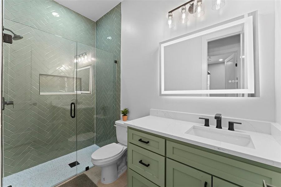 Full bath with a shower stall and vanity Full bath with a shower stall and vanity