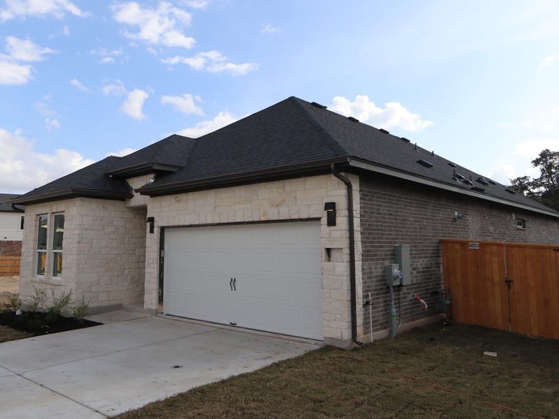 Front exterior of a new home in Heritage, Dripping Springs, TX, highlighting curb appeal (Image 2).