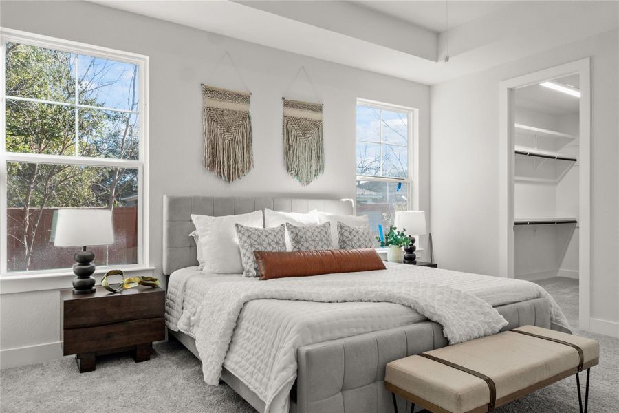 Carpeted bedroom with baseboards and a spacious closet Carpeted bedroom with baseboards and a spacious closet