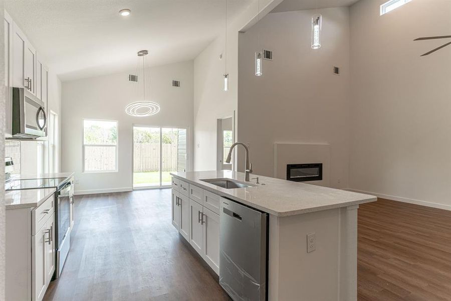 Kitchen looking into living and dining area.  Sliding doorway to back patio