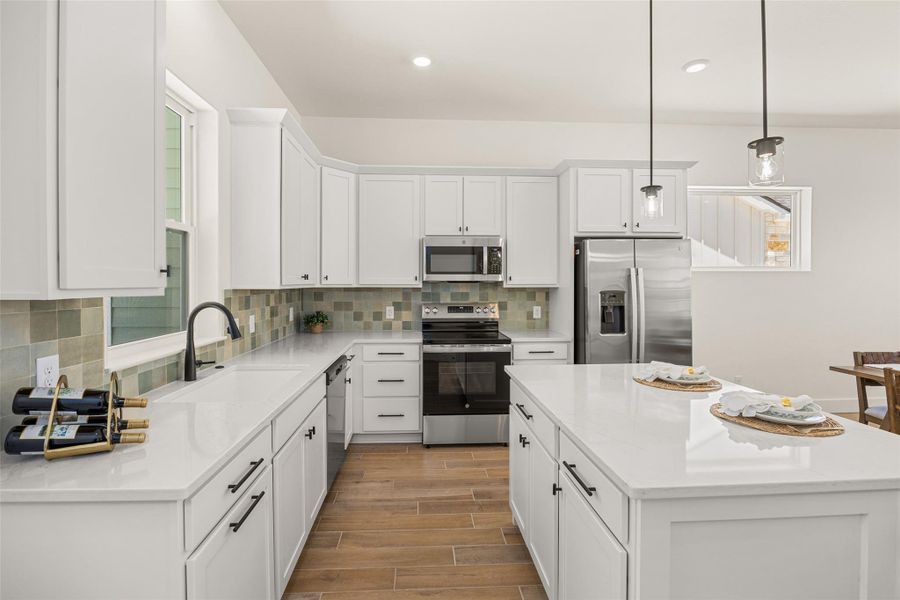 Bright and functional, this kitchen presents clean lines and a central island perfect for culinary pursuits.