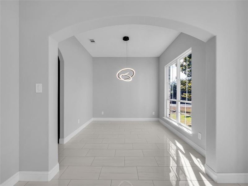 Dining room with stylish light fixture. Dining room with stylish light fixture.