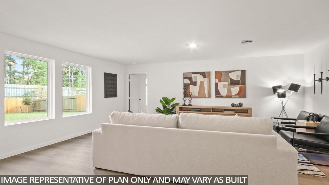Living room with light wood-type flooring and recessed lighting
