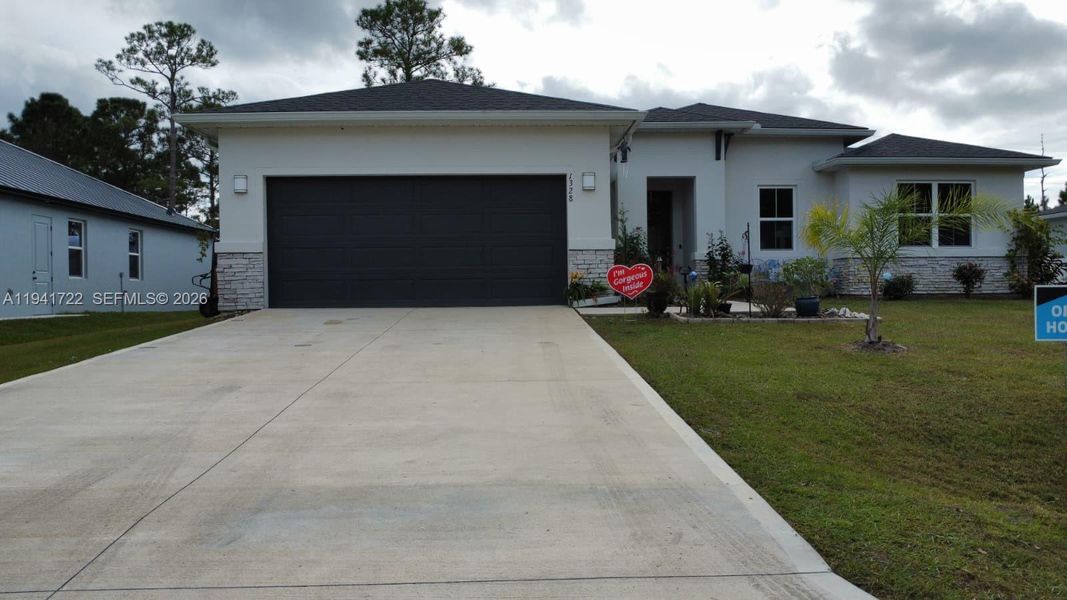 Front exterior of a new home in , Palm Bay, FL, highlighting curb appeal (Image 26).