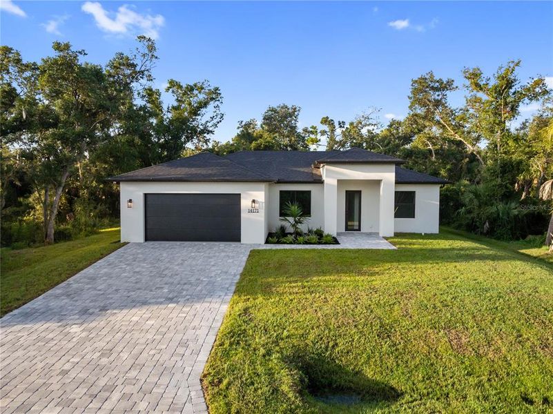 Front exterior of a new home in , Port Charlotte, FL, highlighting curb appeal (Image 24).