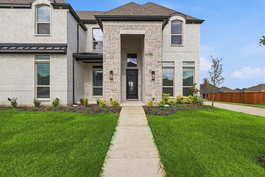 Front exterior of a new home in Cambridge Estates - Harwood, Prosper, TX, highlighting curb appeal (Image 1). Front exterior of a new home in Cambridge Estates - Harwood, Prosper, TX, highlighting curb appeal (Image 1).