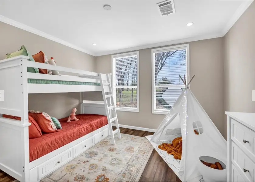 Bedroom with crown molding, wood finished floors, and recessed lighting