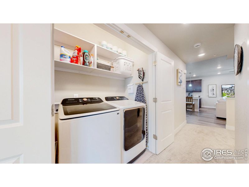 Laundry area has added custom shelves for storage
