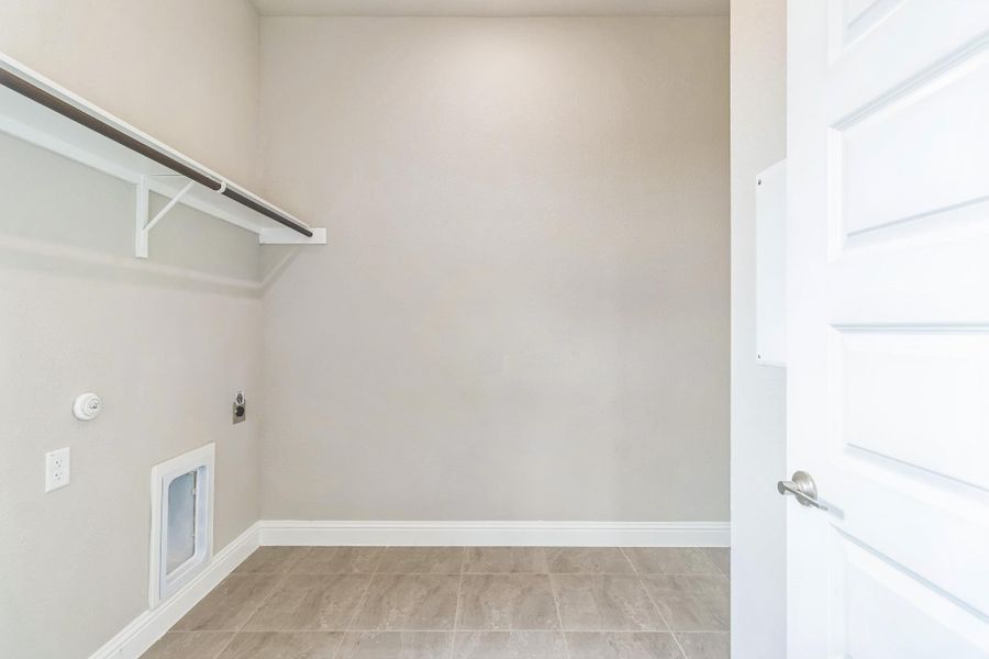 Laundry area featuring hookup for an electric dryer, laundry area, hookup for a gas dryer, and baseboards