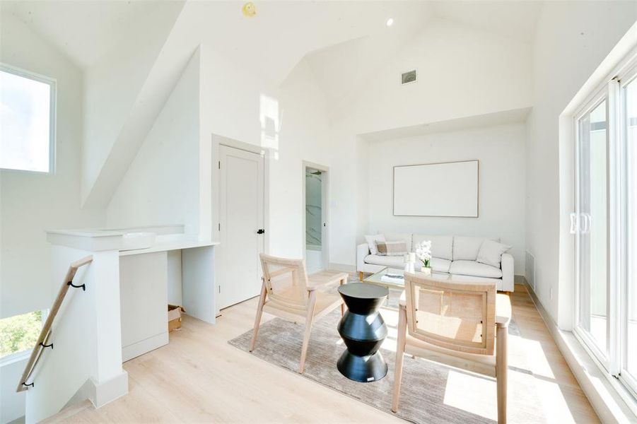 Bathroom with high vaulted ceiling and a wealth of natural light