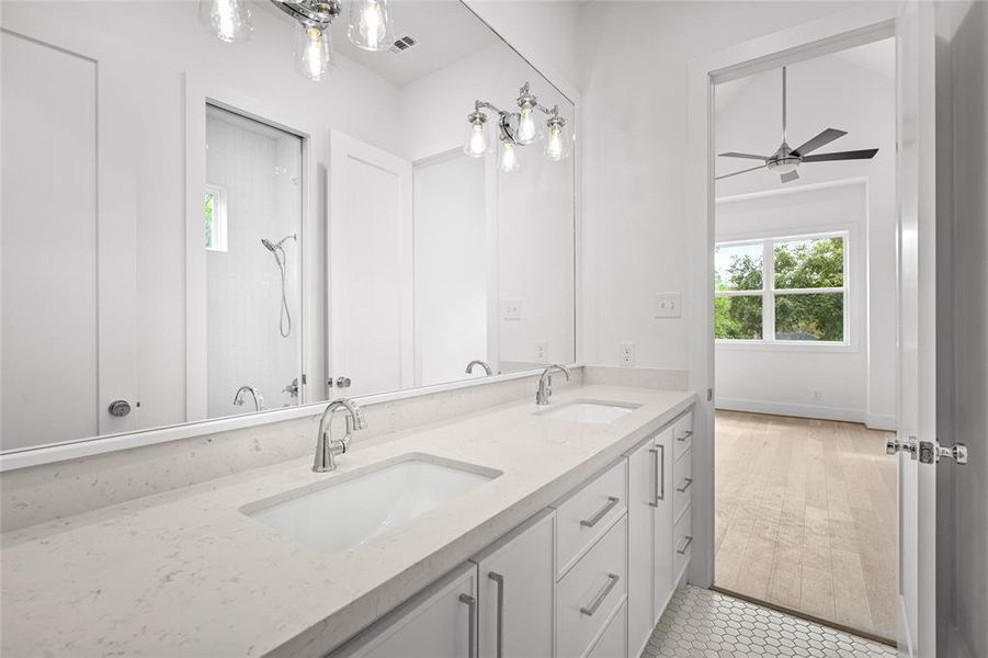 Quality is found throughout the home, including the secondary bathrooms. Custom cabinetry, quartz counters and beautiful tile flooring.