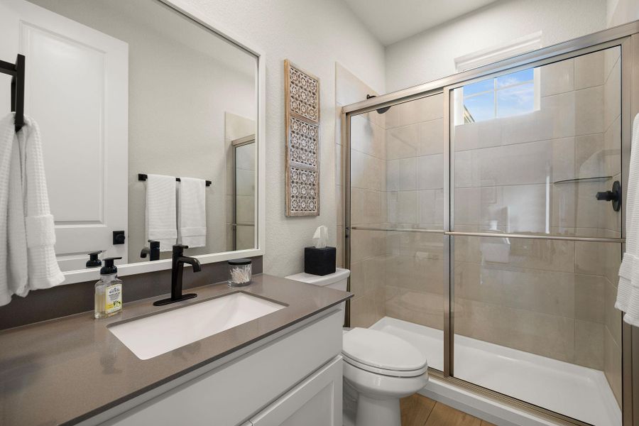 Stylish secondary bathroom with modern vanity and finishes.