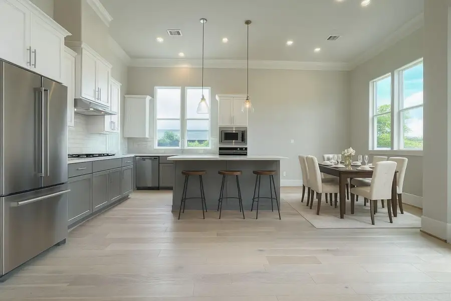 Virtually staged kitchen and dining area.