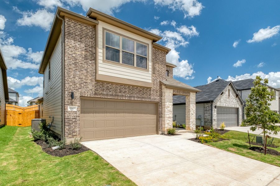 Front exterior of a new home in Trinity Ranch, Elgin, TX, highlighting curb appeal (Image 20).