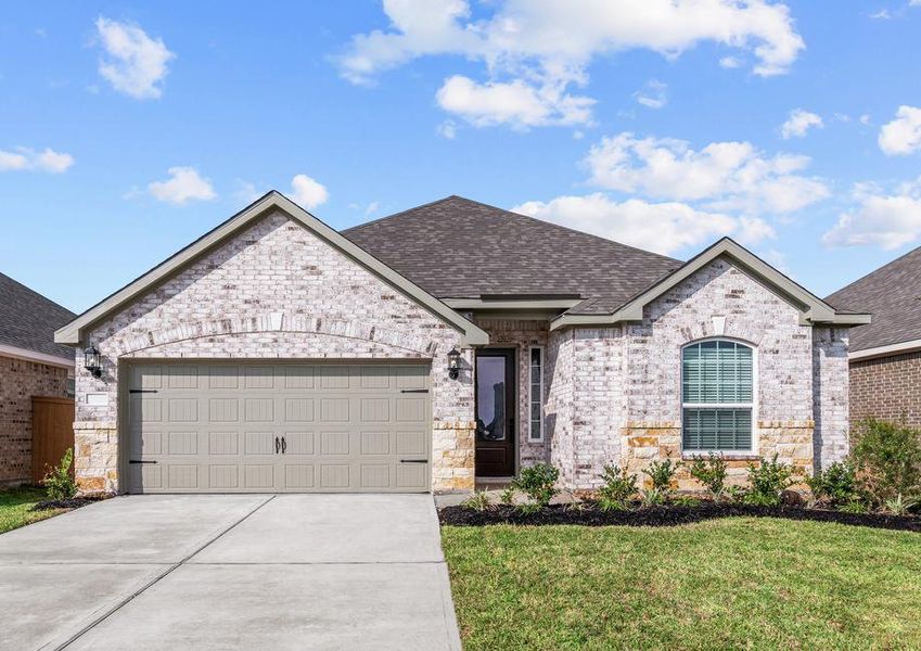 Beautiful single story home with brick and stone and front yard landscaping