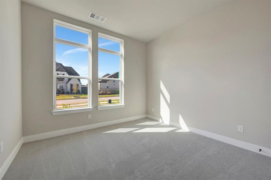 Spare room featuring light carpet and baseboards Spare room featuring light carpet and baseboards