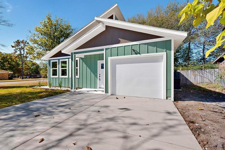 View of front of home featuring board and batten siding, concrete driveway, and a garage View of front of home featuring board and batten siding, concrete driveway, and a garage