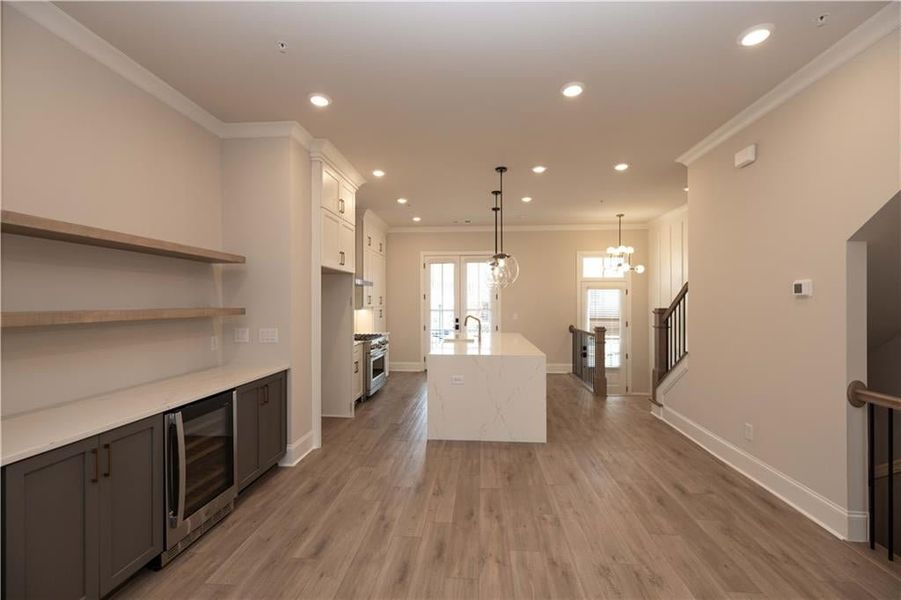 Kitchen/ Dining area:  Perfect space to entertain with the added upgraded Beverage center with wine cooler and floating wood shelves that are site finished and stained to coordinate with the Fireplace mantelpiece.