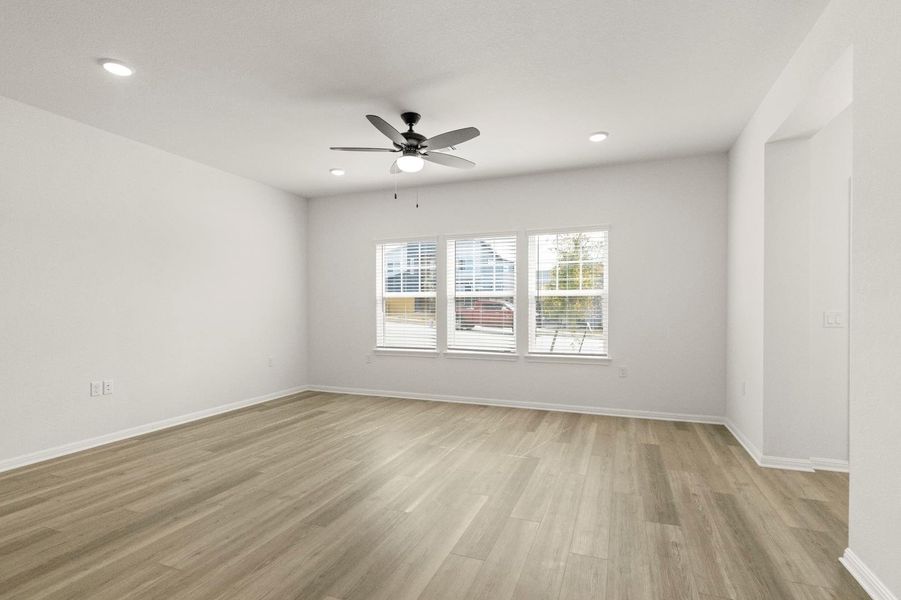 Empty room with light wood-style floors, a ceiling fan, and recessed lighting