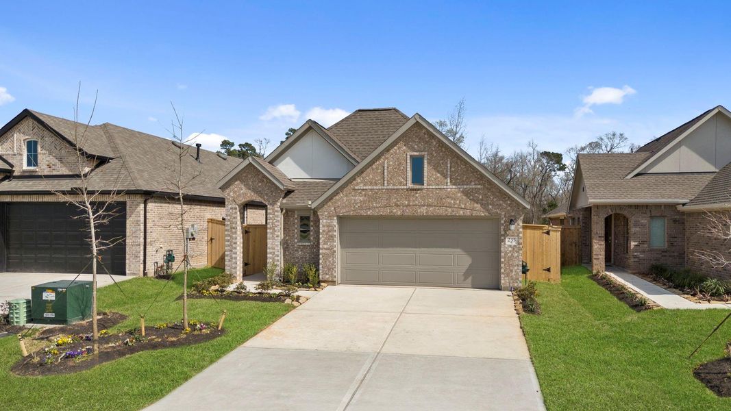 Front exterior of a new home in Grand Central Park, Conroe, TX, highlighting curb appeal (Image 20).