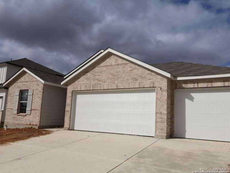 Front exterior of a new home in Greenspoint Heights, Seguin, TX, highlighting curb appeal (Image 1). Front exterior of a new home in Greenspoint Heights, Seguin, TX, highlighting curb appeal (Image 1).