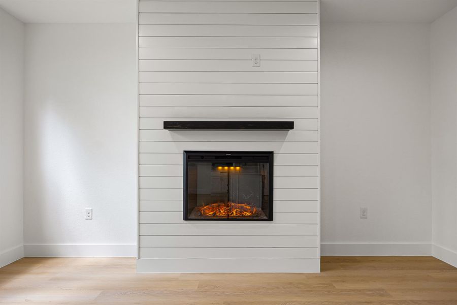 Detailed view of a fireplace and wood finished floors Detailed view of a fireplace and wood finished floors