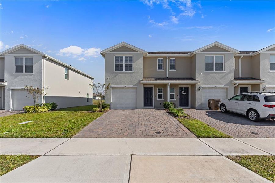 Front exterior of a new home in Harmony West, St. Cloud, FL, highlighting curb appeal (Image 2).