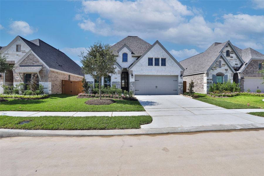 Front exterior of a new home in Marvida 45' - Gated, Cypress, TX, highlighting curb appeal (Image 2). Front exterior of a new home in Marvida 45' - Gated, Cypress, TX, highlighting curb appeal (Image 2).