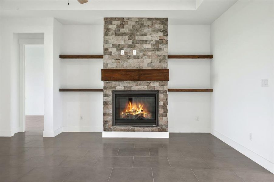 Interior details with ceiling fan, baseboards, and a fireplace Interior details with ceiling fan, baseboards, and a fireplace
