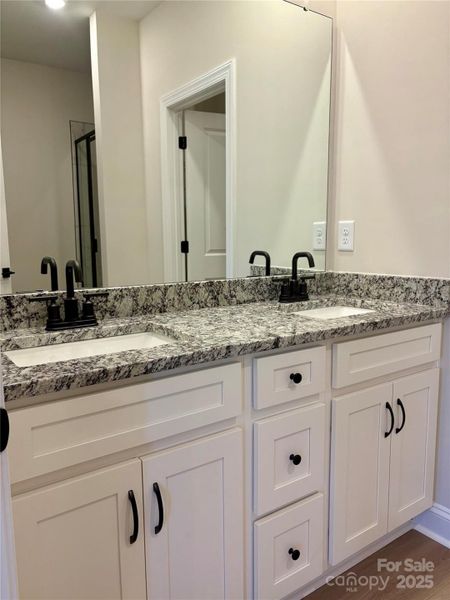 Photo Taken 11/29 Primary On Suite Bath With Dual Sinks, Granite Counters and Black Moen Faucets.
