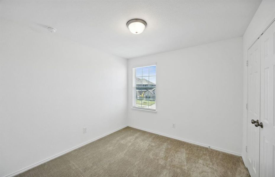 Spacious secondary bedroom with oversized closet *real home pictured