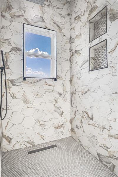 Bathroom featuring a tile shower