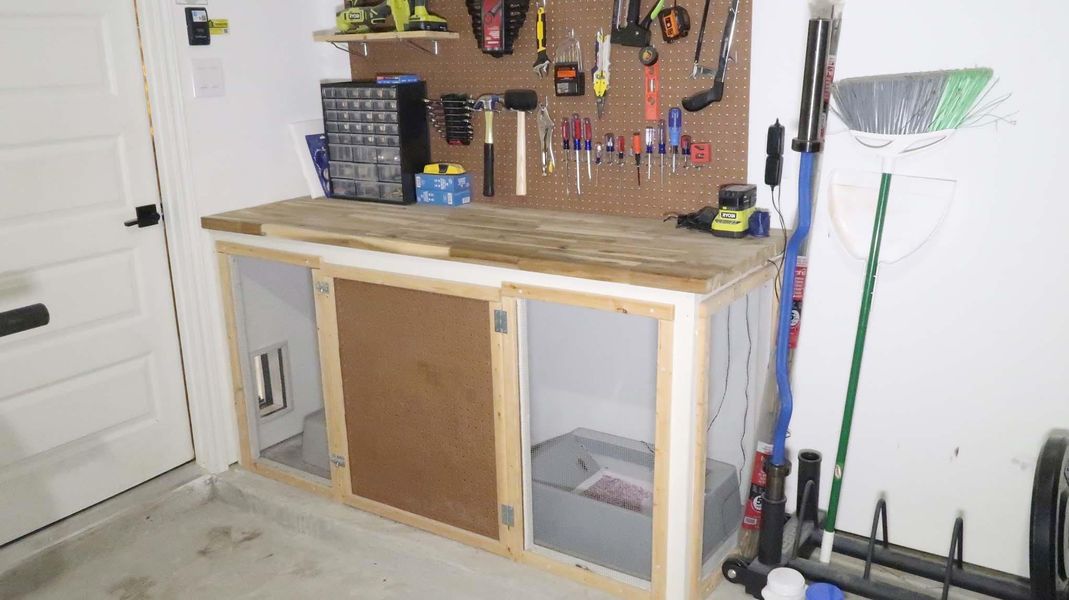 This photo shows a well-organized garage workspace with a wooden workbench, pegboard for hanging tools.Perfect for DIY projects and tool storage. This photo shows a well-organized garage workspace with a wooden workbench, pegboard for hanging tools.Perfect for DIY projects and tool storage.