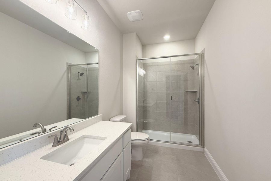 Bathroom with vanity and a shower stall