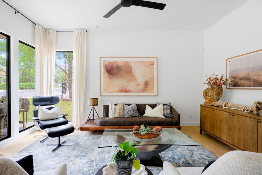 Living room featuring a ceiling fan and light wood finished floors