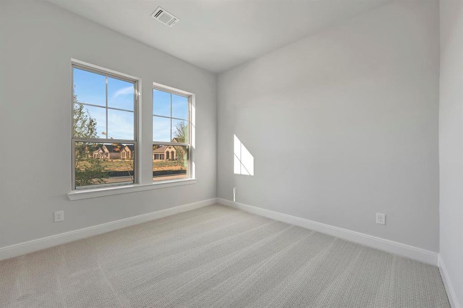 Empty room with light carpet and baseboards