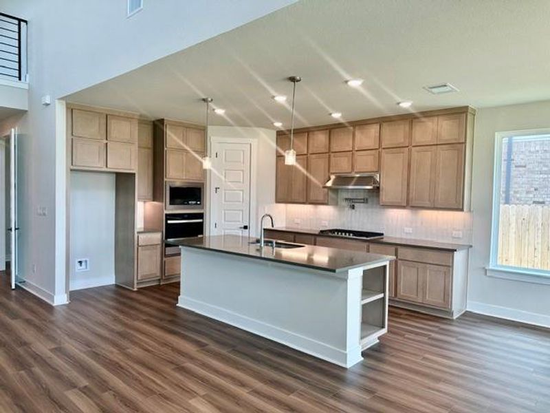 Culinary aspirations come alive in this well-appointed kitchen, boasting an inviting island and ample counter space. Culinary aspirations come alive in this well-appointed kitchen, boasting an inviting island and ample counter space.