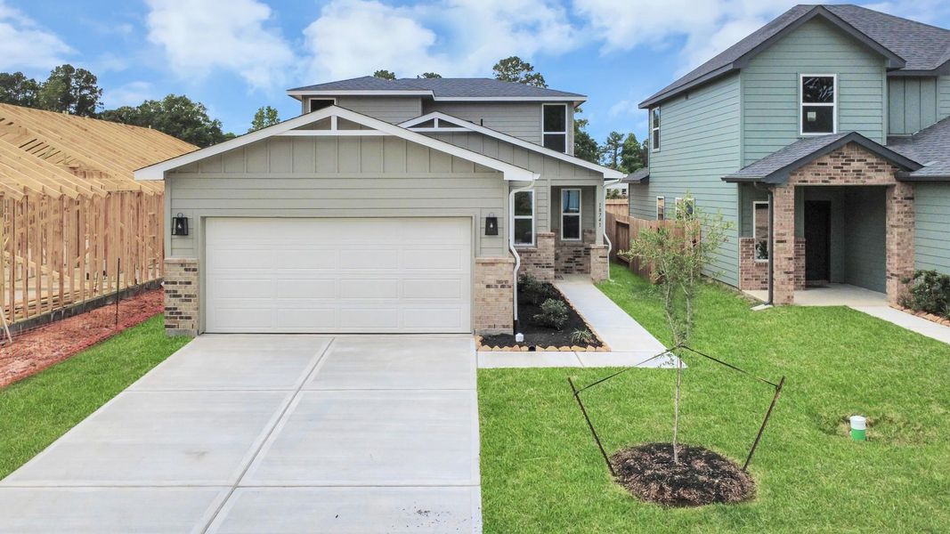 Front exterior of a new home in The Enclave at Spring Branch, Conroe, TX, highlighting curb appeal (Image 24).