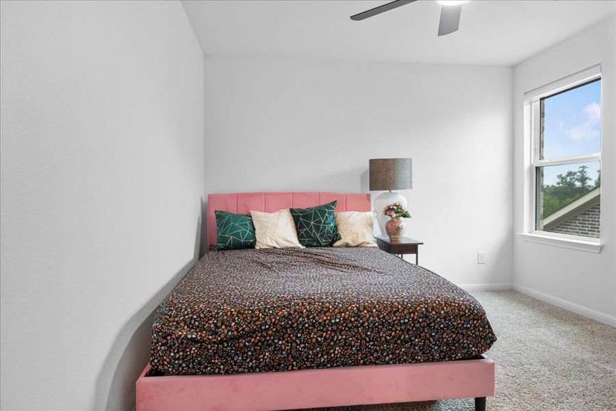 Bedroom featuring light colored carpet and ceiling fan