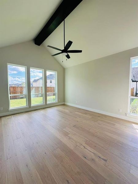 Spare room featuring beam ceiling, light wood-style floors, a ceiling fan, and high vaulted ceiling Spare room featuring beam ceiling, light wood-style floors, a ceiling fan, and high vaulted ceiling